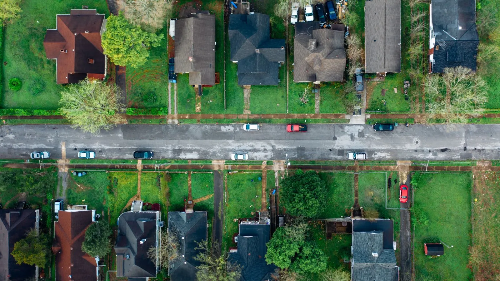 Aerial view of a suburban American neighborhood with houses lining a street